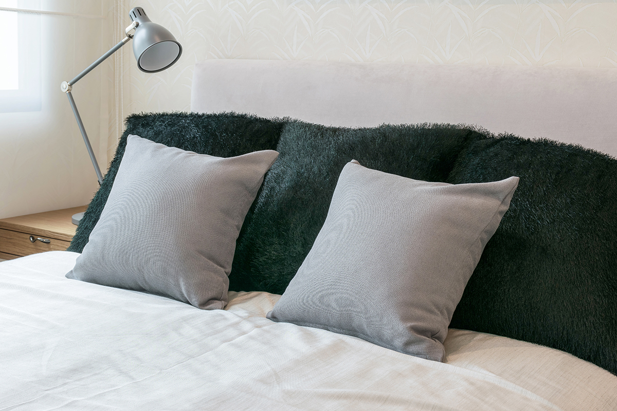 bedroom-interior-design-with-grey-pillows-on-white-bed